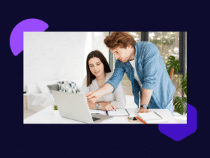 A male CEO pointing to screen while training his business partner